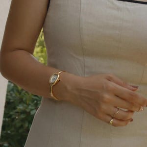 Gold Oval Armreif Uhr, Edelstahl Manschette, Zifferblatt mit römischen Ziffern, Minimalist Schmuck Uhr