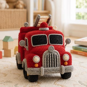 May include: A handcrafted crochet fire truck toy in vibrant red with a grey bumper, grille, and wheels. It features black windshields, a small red siren on the roof, and a cream-colored ladder extending from the back, all rendered in detailed yarn.