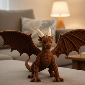 May include: A brown dragon figurine with outstretched wings and cream-colored horns. The dragon is posed on a neutral-colored surface, with a detailed texture and a curled tail. The wings are a darker shade of brown.