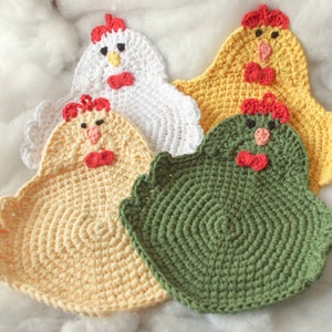 May include: Four crocheted chicken dishcloths in yellow, white, green, and light yellow. Each dishcloth has a red beak, red wattle, and red bow.