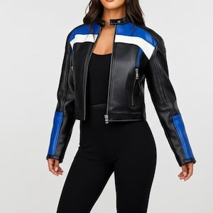 May include: Black faux leather jacket with a stand-up collar, a zipper closure, and blue and white accents on the shoulders and sleeves. The jacket is cropped and has a classic biker style.