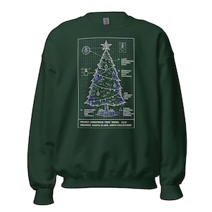 May include: A dark green sweatshirt featuring a blueprint-style Christmas tree design. The tree is decorated with ornaments and a star, with technical details and text at the bottom. The text reads "PROJECT: CHRISTMAS TREE MODEL 25.12 ENGINEER: SANTA CLAUS, NORTH POLE DIVISION."