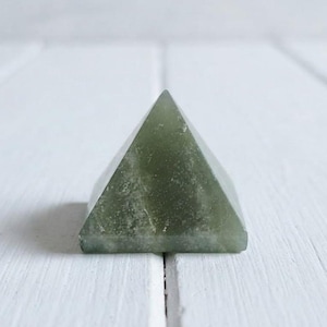 Green aventurine gemstone pyramid in sacred geometry shape, abundance and money attraction crystal for meditation