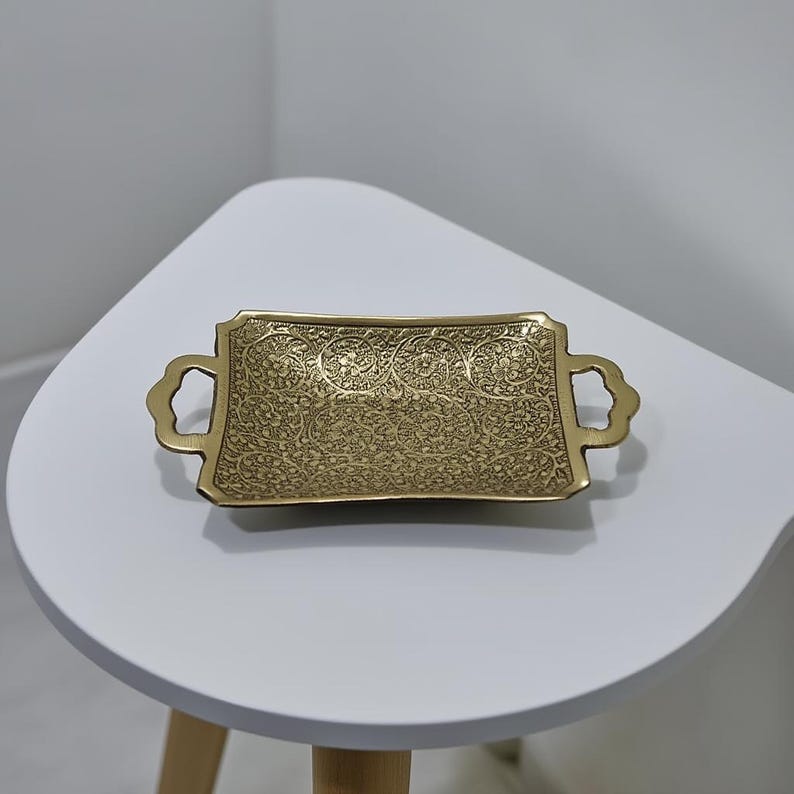 Solid brass tray with cut-out handles and floral etching