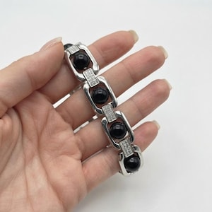 Ebony wood karungali bracelet with linked metal setting, perfect for daily wear and spiritual jewelry collections.