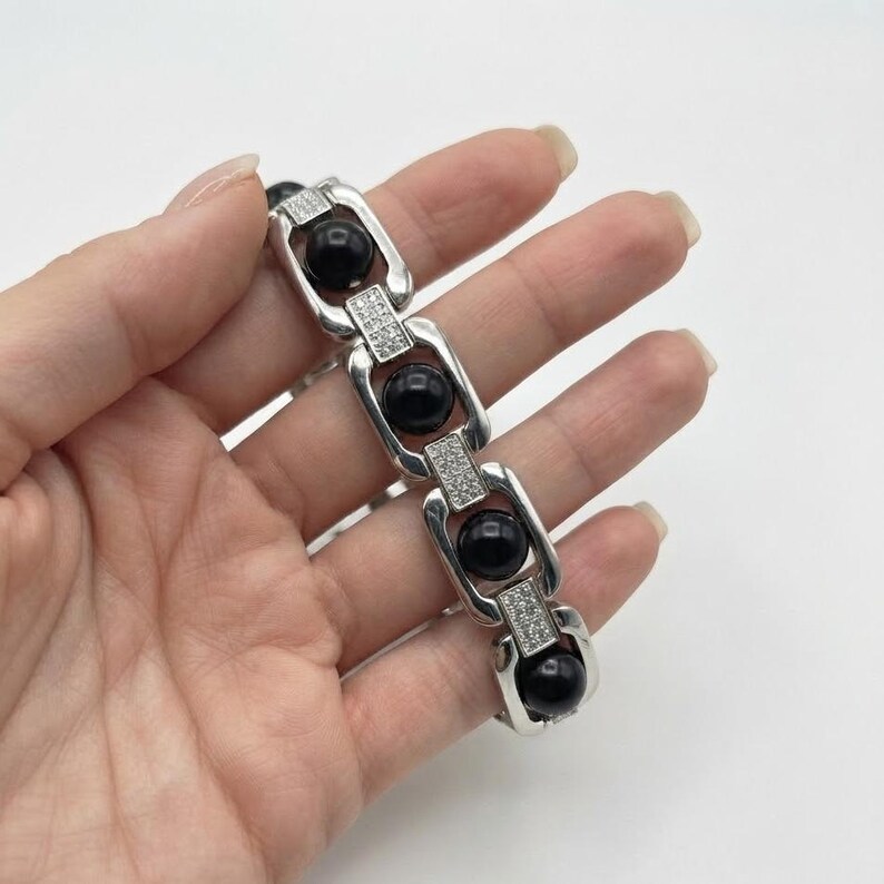 Ebony wood karungali bracelet with linked metal setting, perfect for daily wear and spiritual jewelry collections.