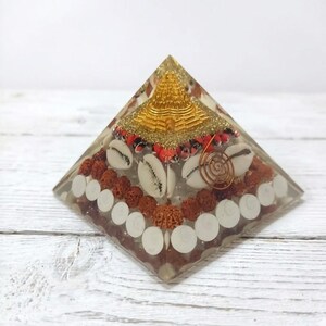 Reiki healing orgonite filled with shells, sacred seeds and copper spiral.