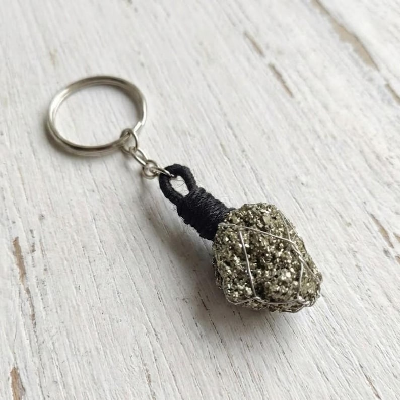 Handmade pyrite crystal keychain with black cord and wire wrap