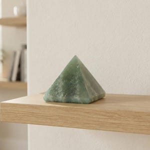 Green aventurine gemstone pyramid in sacred geometry shape, abundance and money attraction crystal for meditation