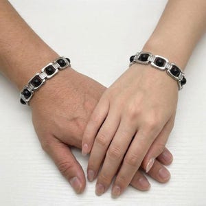 Close-up of natural ebony karungali beaded bracelet showcasing deep black color and secure clasp design for unisex styling.