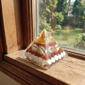 Meditation altar pyramid with conch shells and golden flakes.