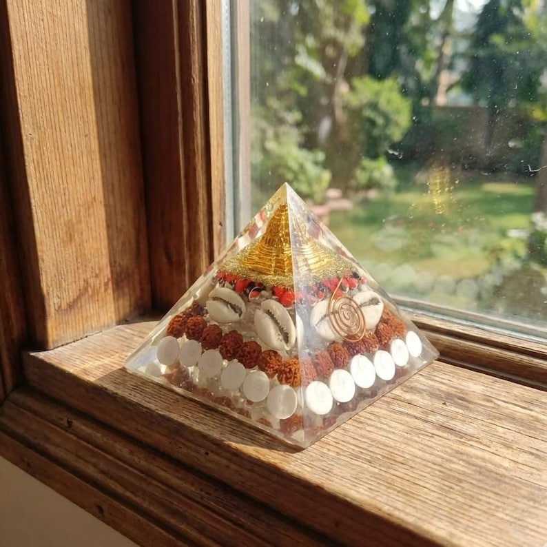 Meditation altar pyramid with conch shells and golden flakes.
