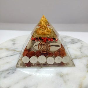 Handmade Buddha orgone pyramid with copper coil and rudraksha beads.