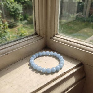 Throat chakra crystal jewelry with soft blue aquamarine stones.
