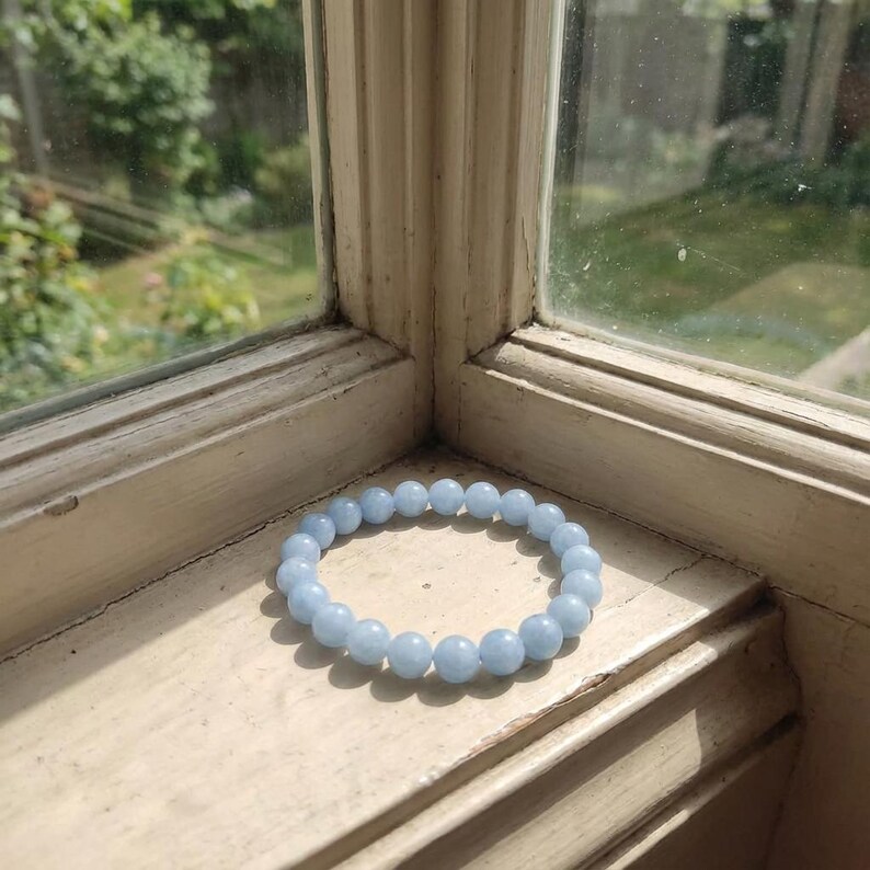 Throat chakra crystal jewelry with soft blue aquamarine stones.