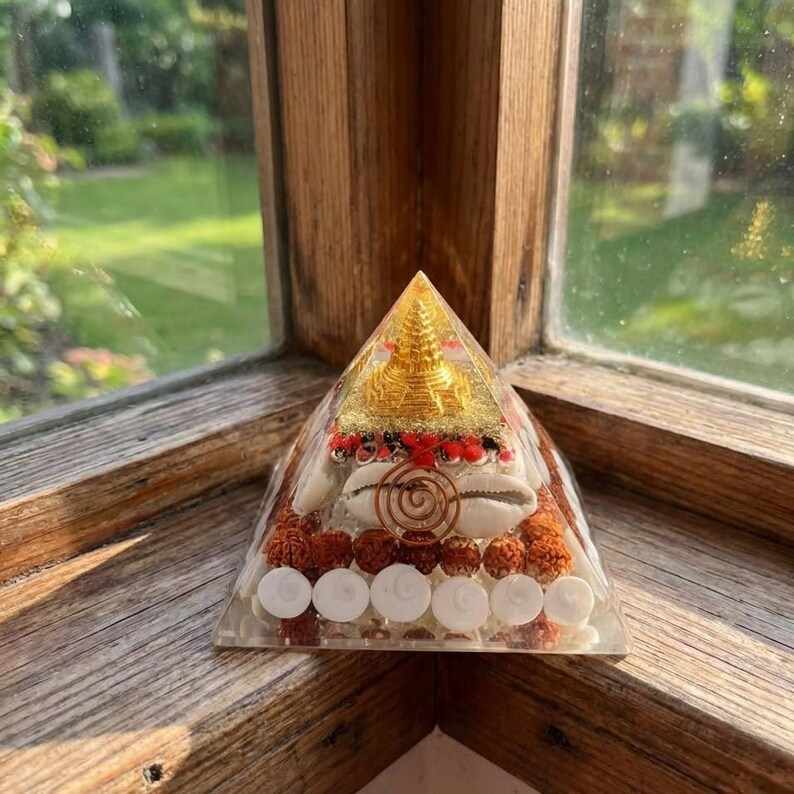 Spiritual pyramid with golden Buddha statue, shell and energy layers.