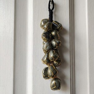 Wire-wrapped pyrite crystal cluster wall hanging in grape shape