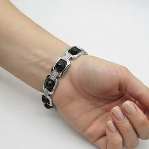 Black karungali wood bracelet displayed on soft background highlighting polished finish and traditional spiritual design.
