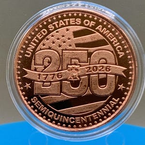 United States of America 250th Anniversary Semiquincentennial copper round featuring Liberty Bell and American flag design, 1776-2026, in protective capsule on blue background