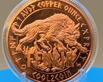May include: A round copper coin encased in a clear plastic capsule. The coin features a relief of a wolf above flames with the text FENRIR, 1 AVP COPPER OUNCE, and TOOL2COIN, surrounded by a border of runic characters in a metallic copper finish.