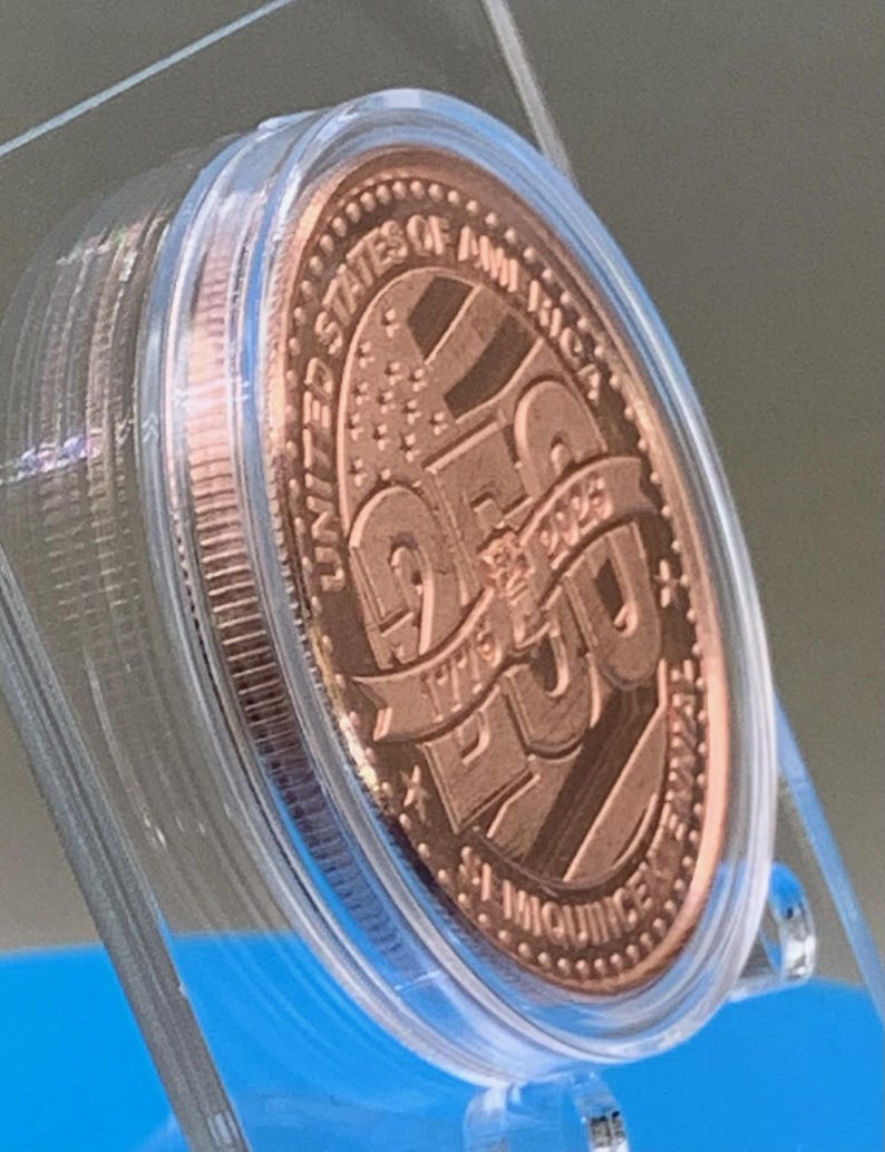Angled view of United States 250th Anniversary Semiquincentennial copper round in a clear protective capsule, showing the 1776-2026 dates and stars-and-stripes design