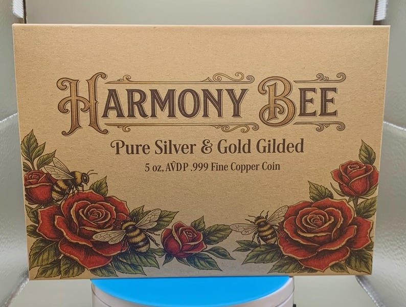 Harmony Bee copper round retail packaging box, kraft-paper lid with rose and bee illustrations, resting on the round's display capsule.