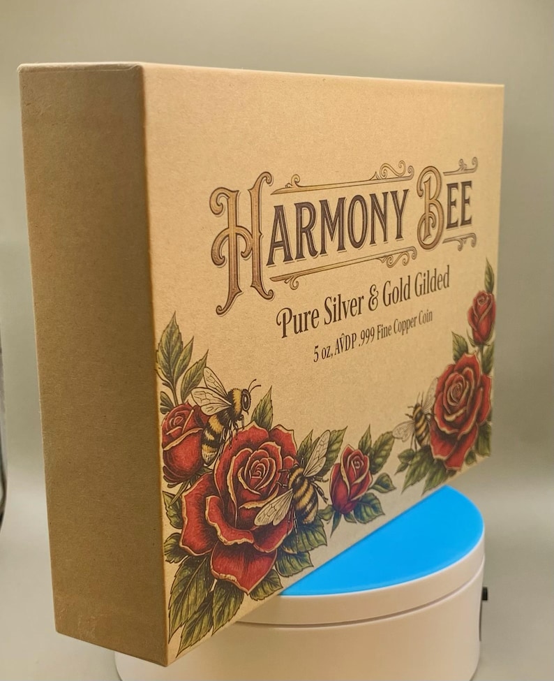 Angled view of the Harmony Bee copper round's kraft-paper packaging box standing upright next to its round display case.