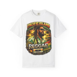May include: White t-shirt featuring a graphic of a man with dreadlocks wearing sunglasses, with the words "Pacific Island Reggae" above and below the image. The design includes palm trees, a sunset, and a cassette tape.