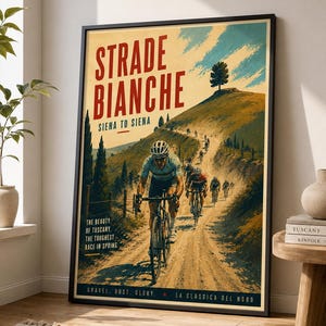 May include: A framed poster featuring a cycling race on a dirt road in Tuscany. The text reads STRADE BIANCHE, SIENA TO SIENA, THE BEAUTY OF TUSCANY, THE TOUGHEST RACE IN SPRING, GRAVEL. DUST. GLORY. LA CLASSICA DEL NORD. Cyclists ride uphill on a path.