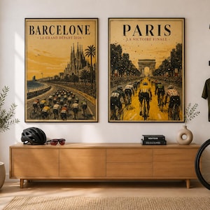 May include: Two rectangular wall posters featuring cycling race scenes. The left poster shows Barcelona with the text BARCELONE LE GRAND DÉPART 2026. The right poster shows Paris with the text PARIS LA VICTOIRE FINALE. Both have a warm yellow tone.