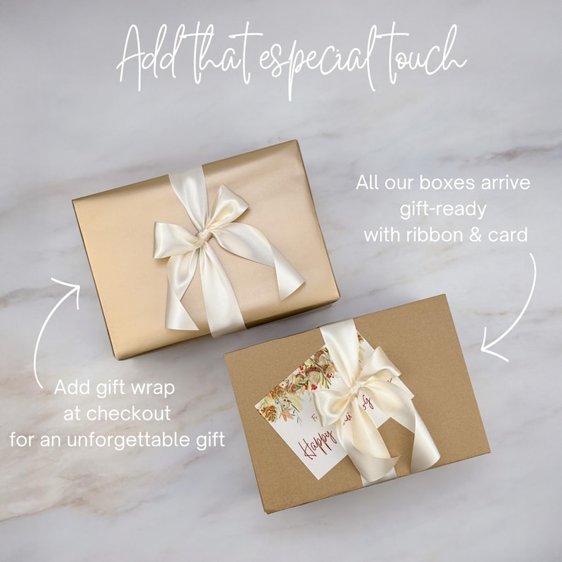 May include: Two gift boxes wrapped in gold and brown paper, tied with ivory satin ribbons. One box has a gift tag that says "Happy". The text in the image says "Add that especial touch".