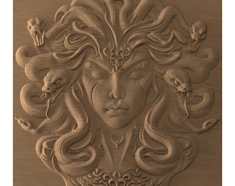 May include: A detailed wooden carving of Medusa's face, with snakes for hair. The carving is in a light brown colour, with intricate details on the face and snakes. The snakes have open mouths, and the design is a relief sculpture.