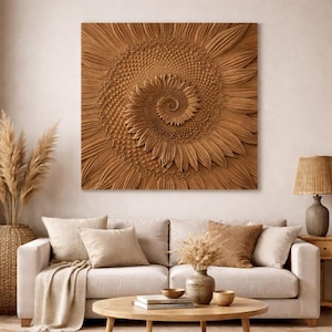 May include: A large, square wooden wall art piece featuring a detailed, carved sunflower design. The sunflower's petals and spiral center are intricately carved, showcasing a natural, warm brown color. The artwork hangs above a beige sofa in a living room setting.