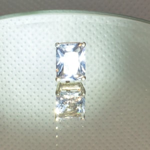 White sapphire tie tack in silver.