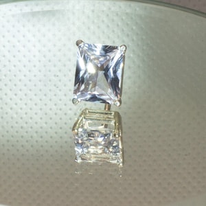 Large white sapphire tie tack in silver.