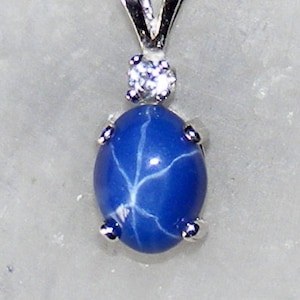 Blue star sapphire  accented pendant.