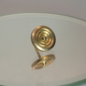 Brass shield tie tack.