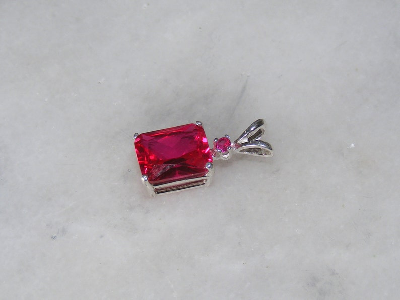 Ruby pendant with ruby accent mounted in silver.9x7 image 3