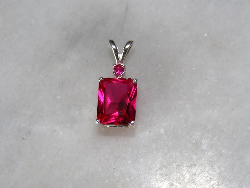 Ruby pendant with ruby accent mounted in silver.9x7 image 2