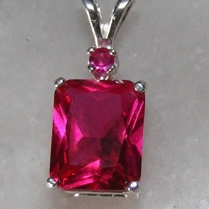 Ruby pendant with ruby accent mounted in silver.9x7 image 1