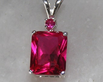 Ruby pendant with ruby accent mounted in silver.(9x7)
