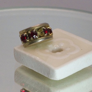 Row of four stones tie tack.