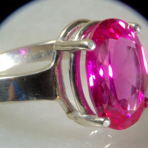 Huge pink oval sapphire ring.