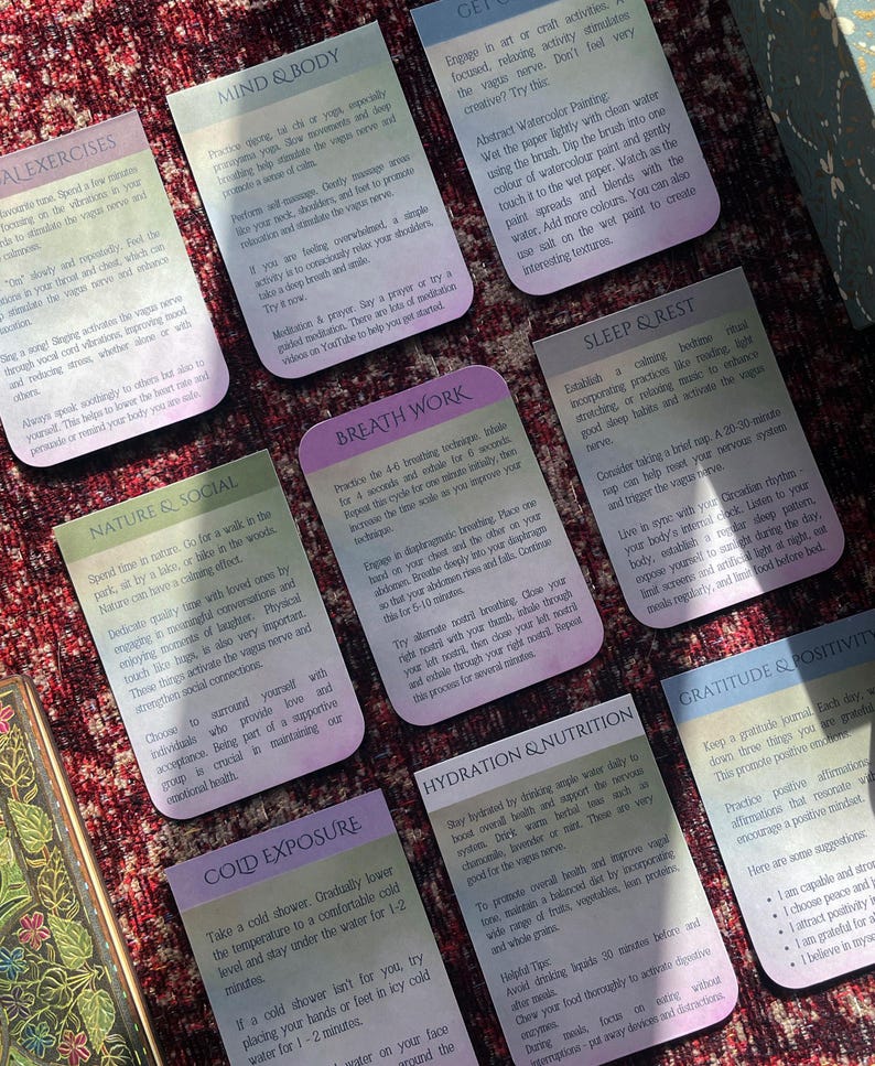 May include: A set of colorful cards with tips for improving mental and physical well-being. Each card features a different topic, such as nature & social, breath work, sleep & rest, cold exposure, hydration & nutrition, gratitude & positivity, and mind & body.