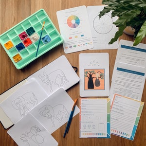 May include: A set of art supplies for creating Tinga Tinga art, including a paint palette, paintbrushes, a sketchbook with animal illustrations, and instructions on how to create Tinga Tinga art.