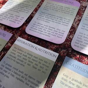 May include: A set of colorful cards with tips for self-care and well-being. The cards feature text in a light gray font on a gradient background. The card titles include "Nature & Social", "Breath Work", "Hydration & Nutrition", and "Gratitude".