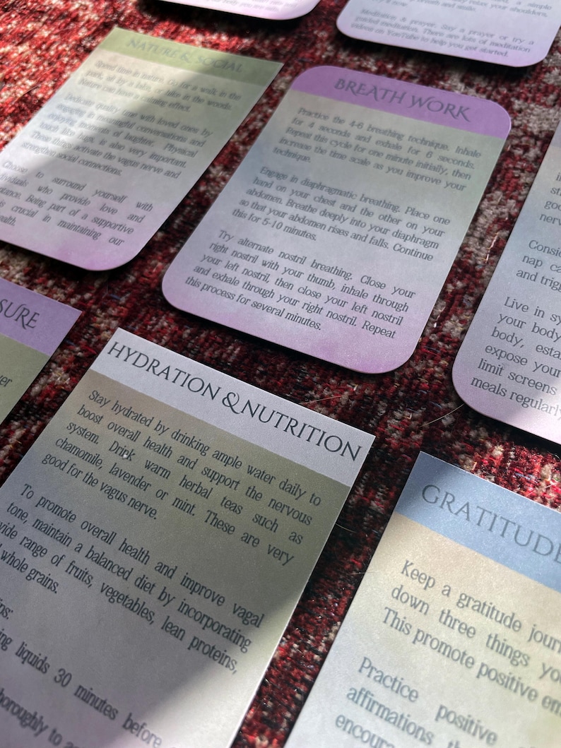 May include: A set of colorful cards with tips for self-care and well-being. The cards feature text in a light gray font on a gradient background. The card titles include "Nature & Social", "Breath Work", "Hydration & Nutrition", and "Gratitude".