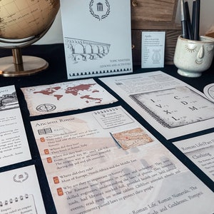 May include: A set of educational materials for learning about ancient Rome. The materials include a map, a globe, a book, and several worksheets. The worksheets feature Roman numerals, Roman life, and Roman gods and goddesses. The text on the worksheets reads "Explore Ancient Rome" and "Roman Life/Part 1: Clothing".