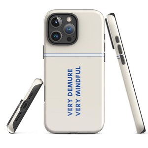 May include: Off-white phone case with a blue horizontal stripe and the words "VERY DEMURE VERY MINDFUL" in blue. The case has a black border and is shown from multiple angles.