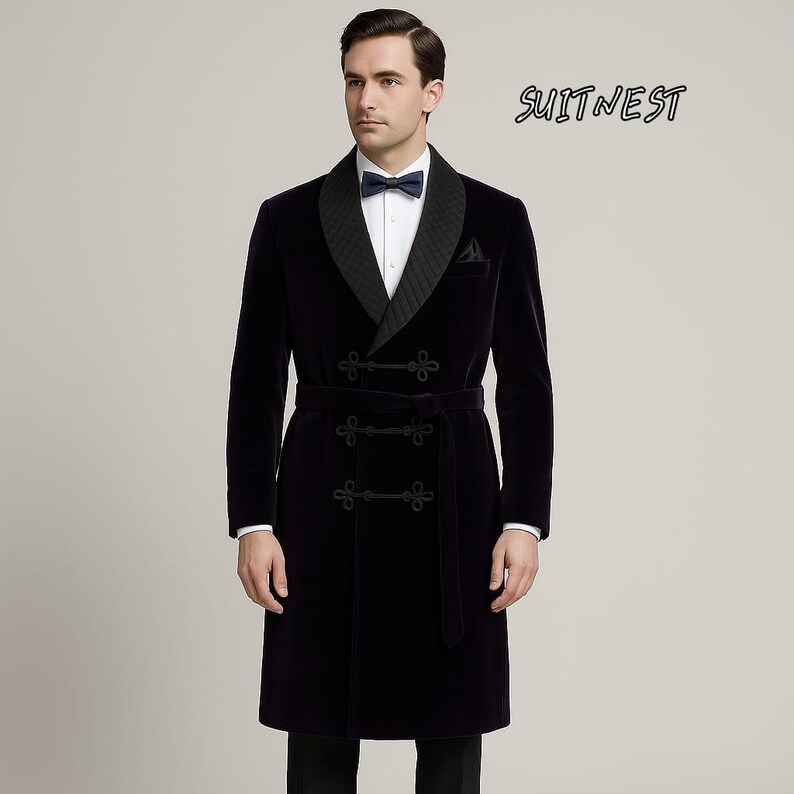 May include: A dark navy velvet robe with a quilted lapel and a matching belt. The robe has a double-breasted closure with decorative buttons and a small pocket. The text "SUITNEST" is visible in the upper right corner.